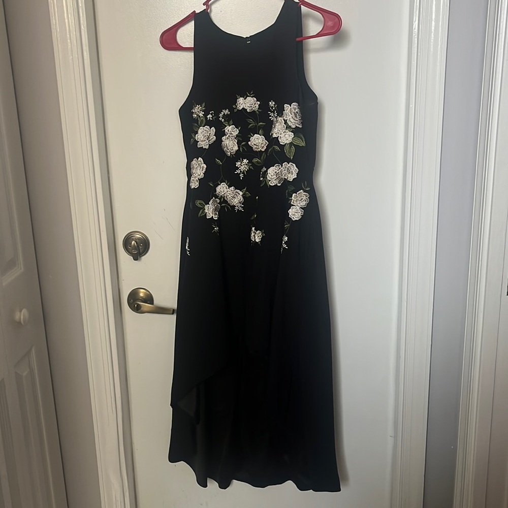 black dress long in the back short in the front roses embroidered on it